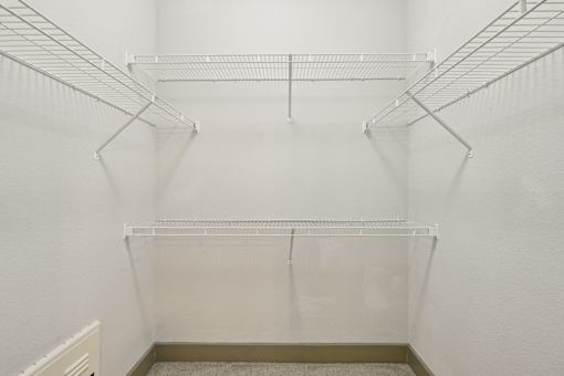 Empty white shelves in a room.
