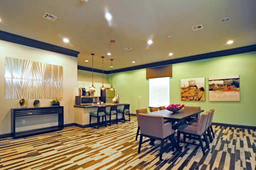 A dining room with a table set for six.