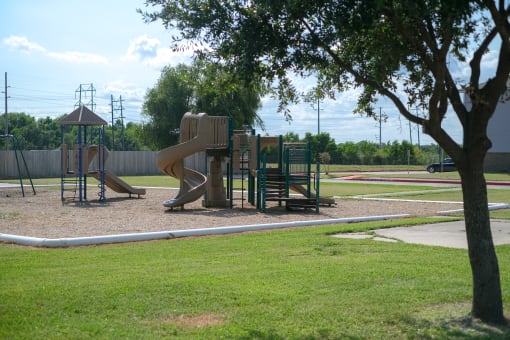 a playground with a slide in a park