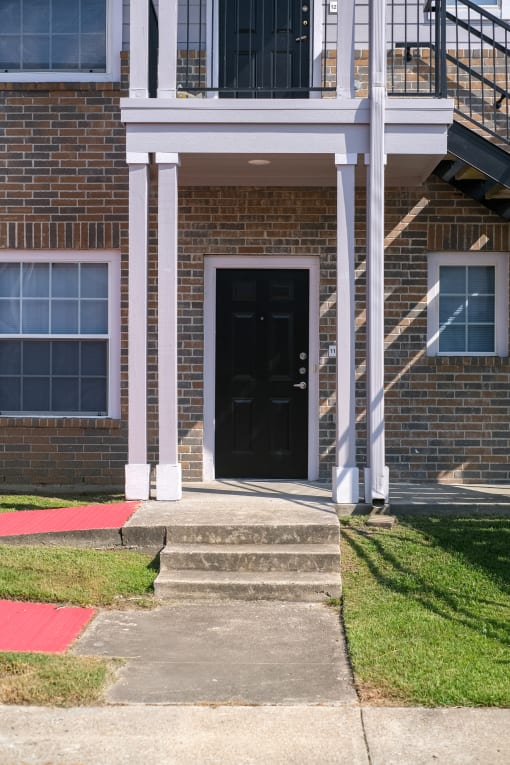 a brick building with a black door