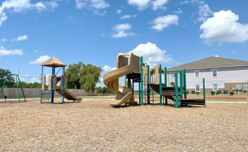 a playground with a slide and monkey bars
