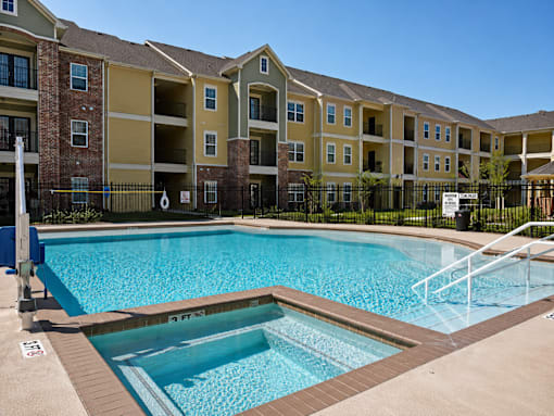 A swimming pool in front of apartment buildings.