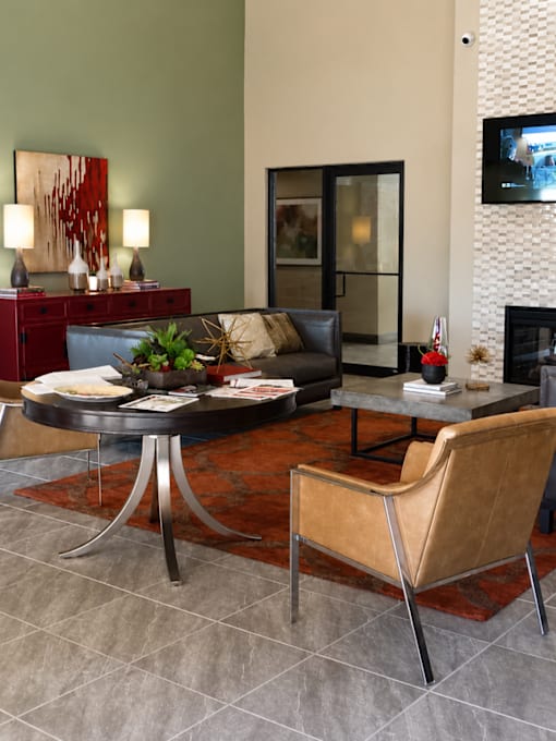 A living room with a black table and a brown chair.