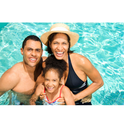 A family of three is enjoying a swim in a pool.