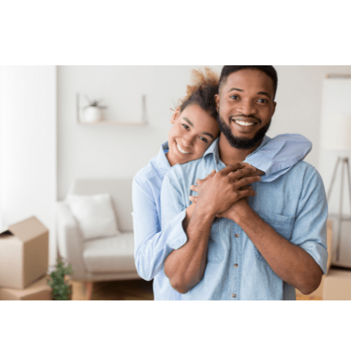 A man and woman in a room with boxes, possibly moving in.