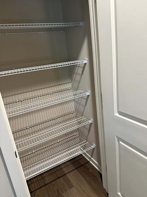 Empty shelves in a white refrigerator.