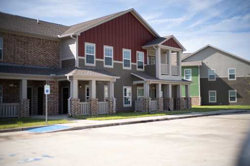 A row of houses with a blue sign in front of them.