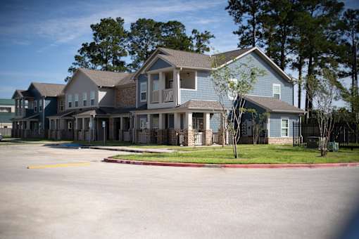 A large house with a driveway in front.