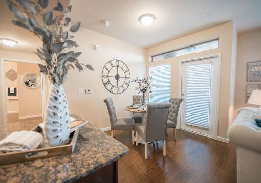 A dining room with a table set for four.