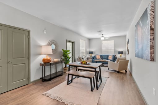 an open living room and dining room with a table and chairs