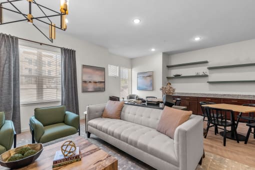a living room with a couch and a table with chairs