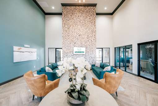 A reception area with a table in the middle and chairs on either side.