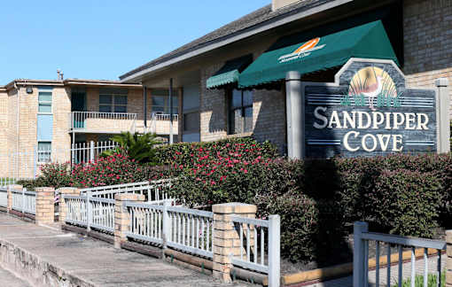 Sandpiper Cove is a residential building with a green awning.
