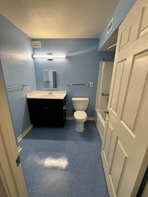 A bathroom with blue walls and a white sink.