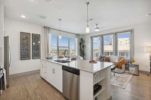 A modern kitchen with a large island and stainless steel appliances.