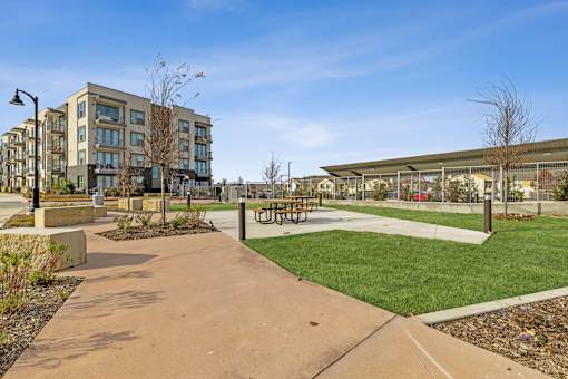 Apartment community exterior with manicured lawn and multi-story building