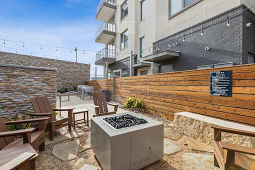 Private outdoor terrace with stone accent wall and wood fence