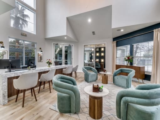 a living room with green chairs and a bar and windows  at Vibe on Riverside, Austin, TX