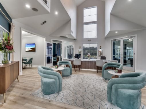 a large living room with blue chairs and a rug  at Vibe on Riverside, Austin, TX