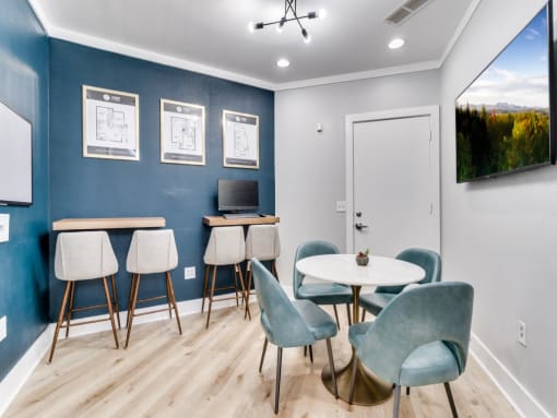 a meeting room with chairs and tables and a tv  at Vibe on Riverside, Austin