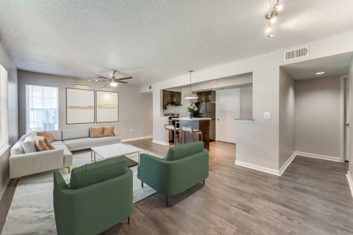 a living room with couches and chairs and a dining room with a kitchen  at Vibe on Riverside, Austin, TX