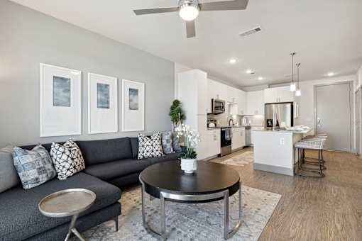 Modern living room with sectional sofa, wood-style flooring and city views