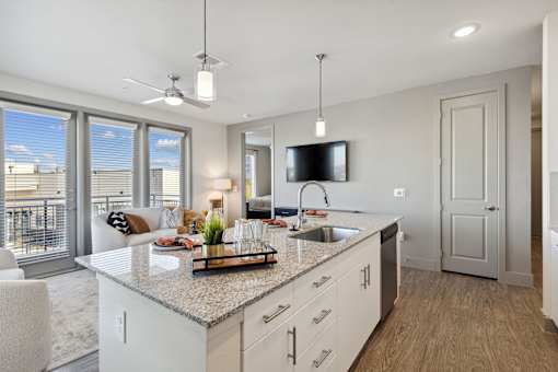 Kitchen island with white quartz countertop and modern pendant lighting