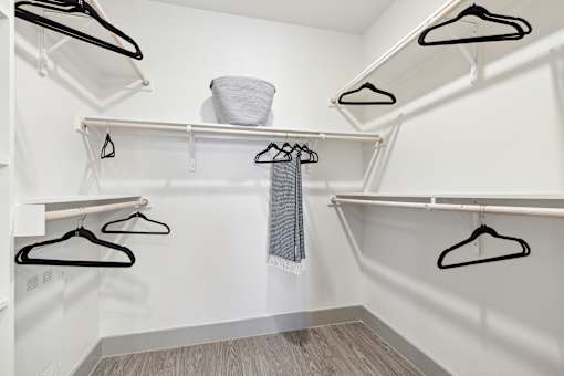 Walk-in closet with dual hanging rods and open shelving system