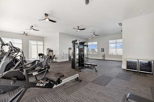 Apartment fitness center with strength training equipment and natural light