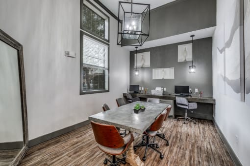 a conference room with a table and chairs and a large window  at Valor at Harlingen, Harlingen