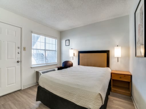 a bedroom with a bed and a window  at Waterford Studios, Austin