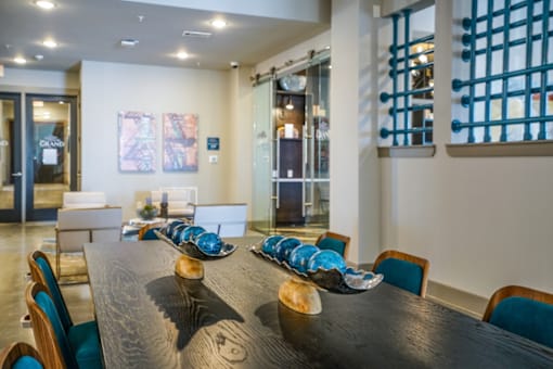 A long wooden table with blue and white plates on it.