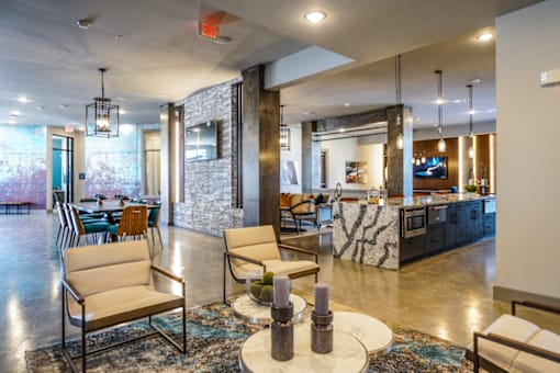 A modern living room with a stone wall and a fireplace.