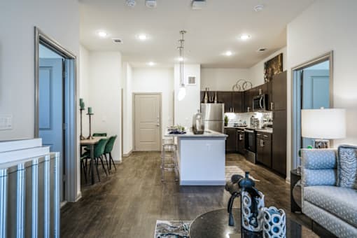 A modern kitchen with a dining table and chairs.