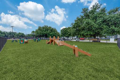 a park with a seesaw in the middle of the grass at Vibe on Riverside, Austin, TX, 78741