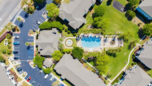 A bird's eye view of a neighborhood with a pool and a playground.