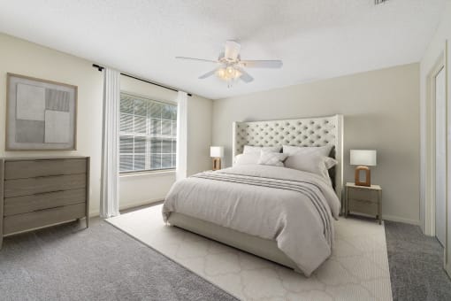 a bedroom with a bed and a ceiling fan at Baldwin Farms Apartments, Alabama