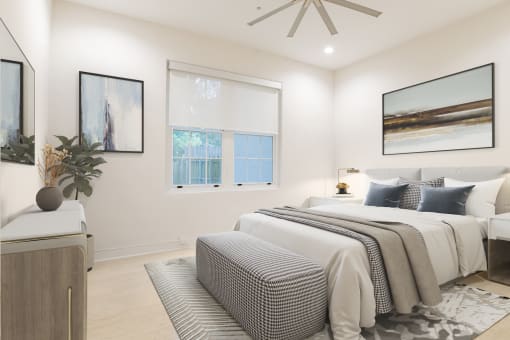 a white bedroom with a bed and a ceiling fan