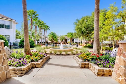 A beautifully landscaped garden with a fountain at its center.