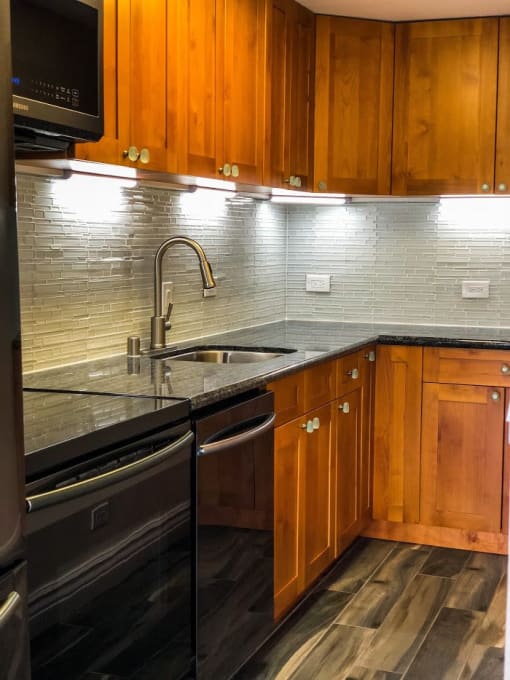 Napili Towers kitchen area with appliances, cabinets, and counters
