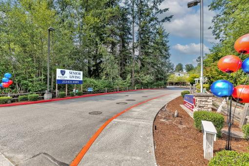 an empty road with balloons on the side of a road