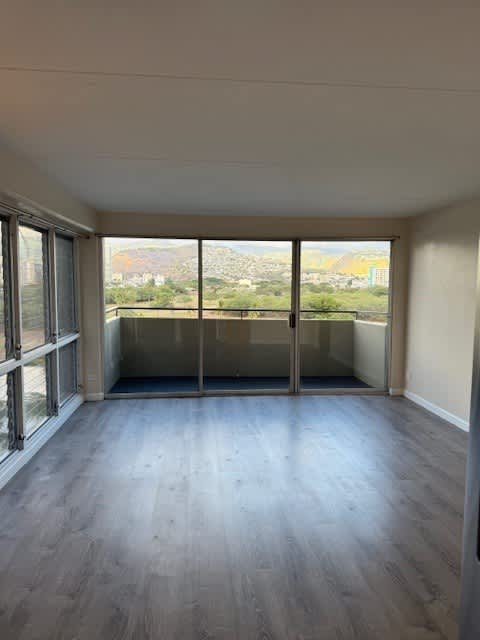 A room with a view of the city through large windows.