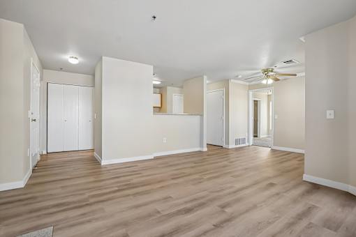 Pines at Castle Rock 2728 living room with wooden flooring and white walls.