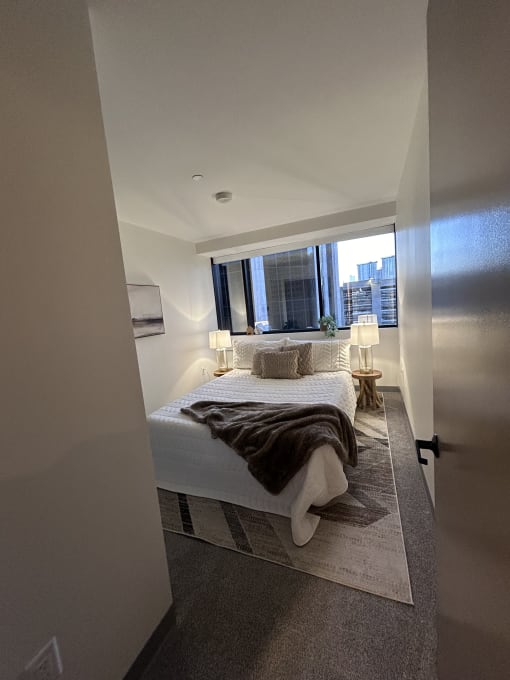 a small bathroom with a shower and a bed in it