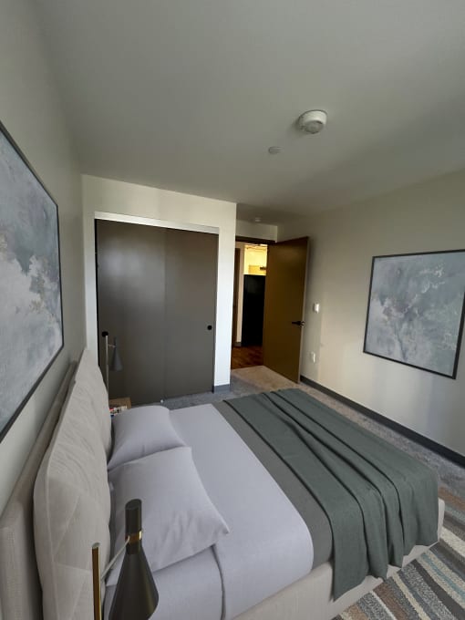 a bedroom with a bed and a door to a bathroom