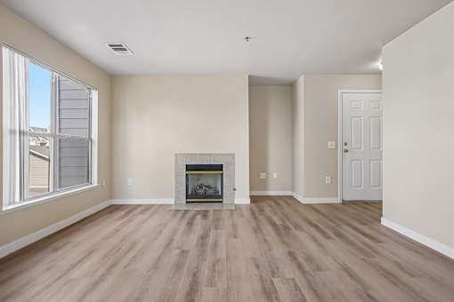 Pines at Castle Rock 2728 living room with a fireplace and wood flooring.