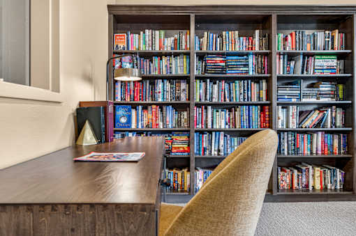 A bookshelf filled with books in a room.