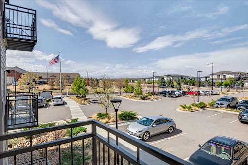 A parking lot with cars and a building in the background.