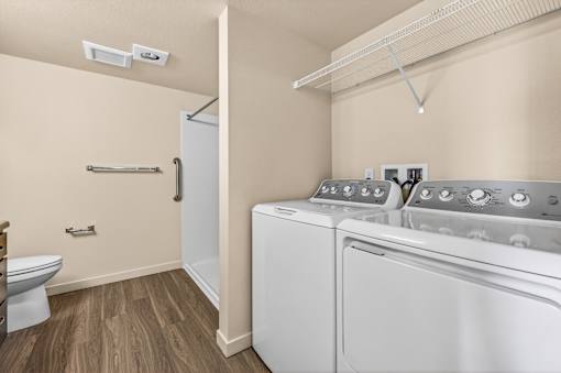 A small laundry room with a washer and dryer.