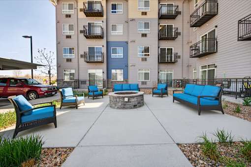 A large outdoor patio area with a fire pit and seating.